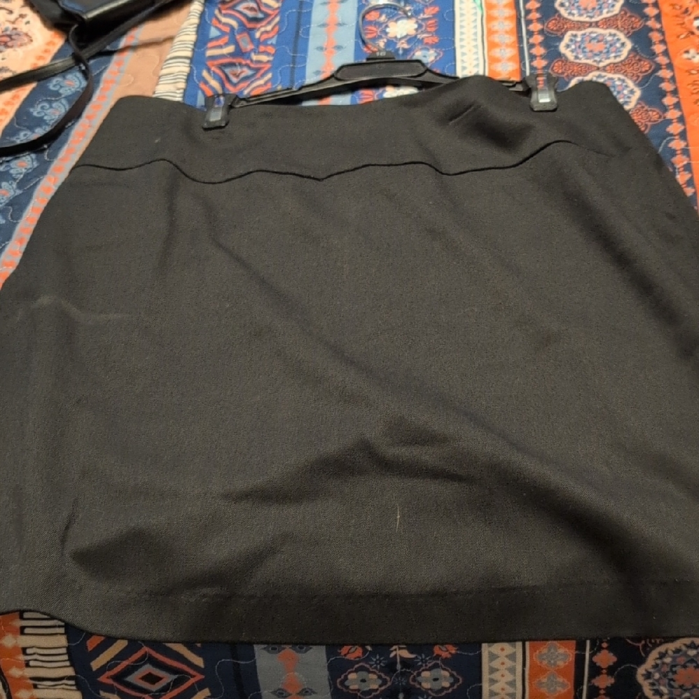 Short Black skirt. Slit in the back Zipper